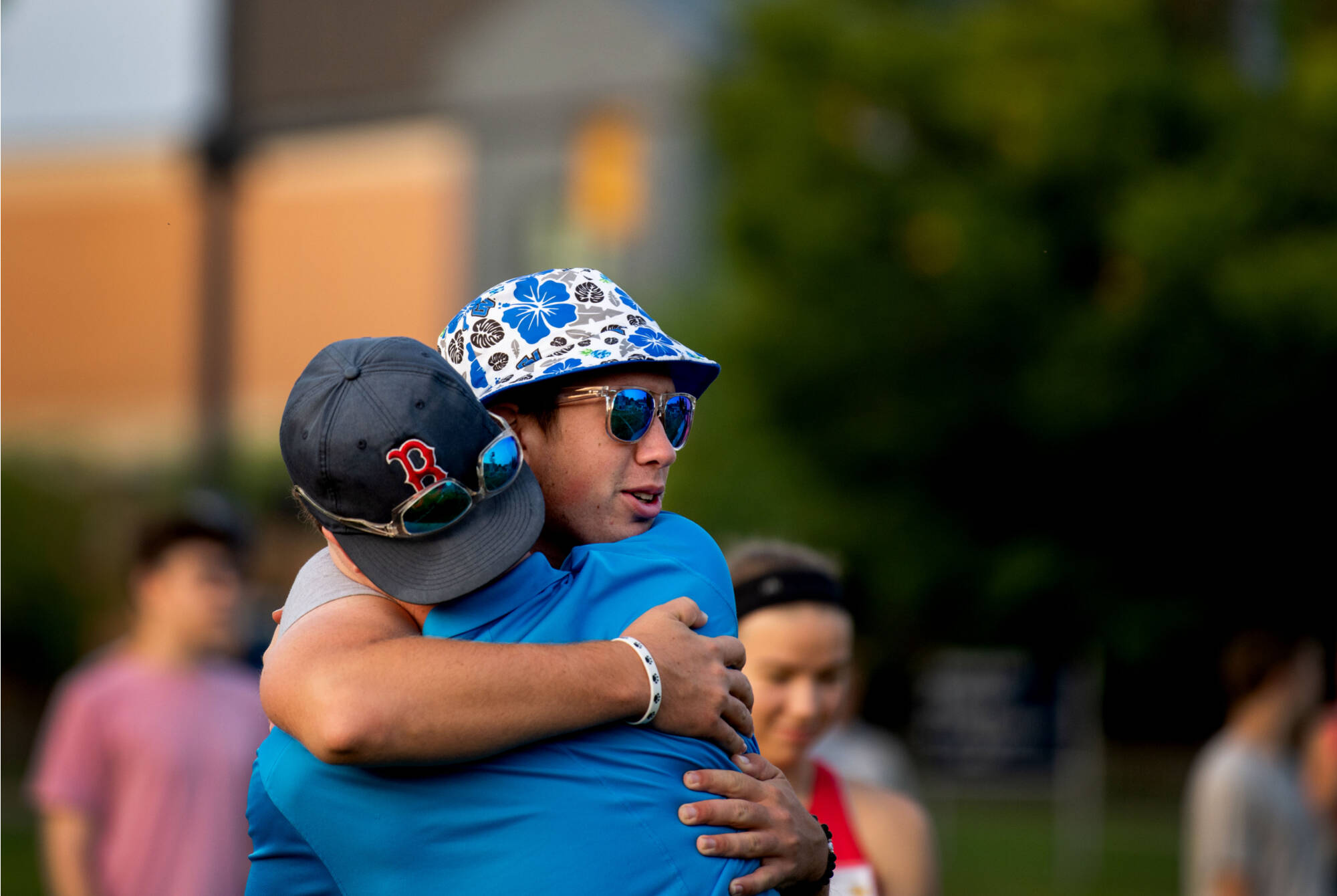 Matthew Alarie, left, hugs a band member during the end of band camp.